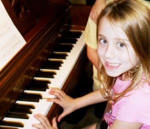 Child learning to play the piano